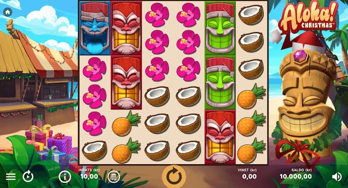 Aloha! Christmas slot med tropisk juldesign. Tiki-masker med tomtemössa kombinerat med tropiska frukter, blommor och snäckor.